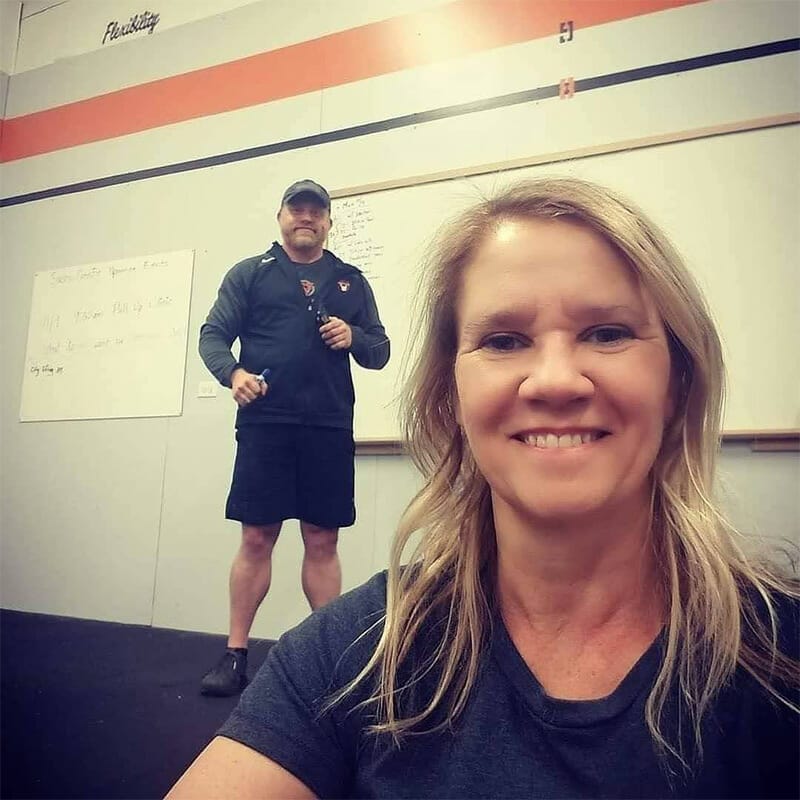 Coach Jennifer Owner of Northglenn Health and Fitness with Coach Patrick in the background