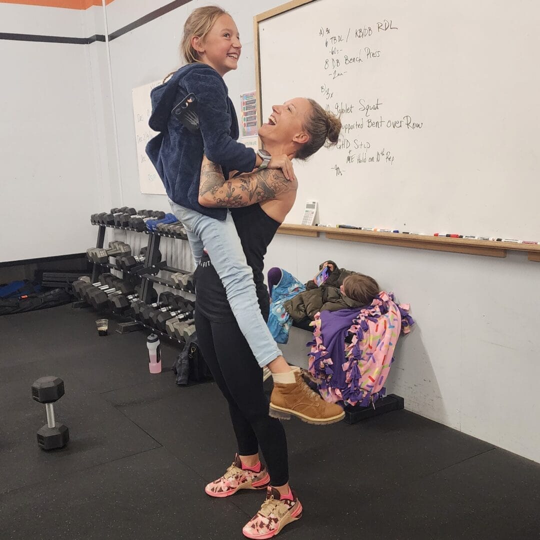 Catherine easily lifting her daughter because of functional fitness