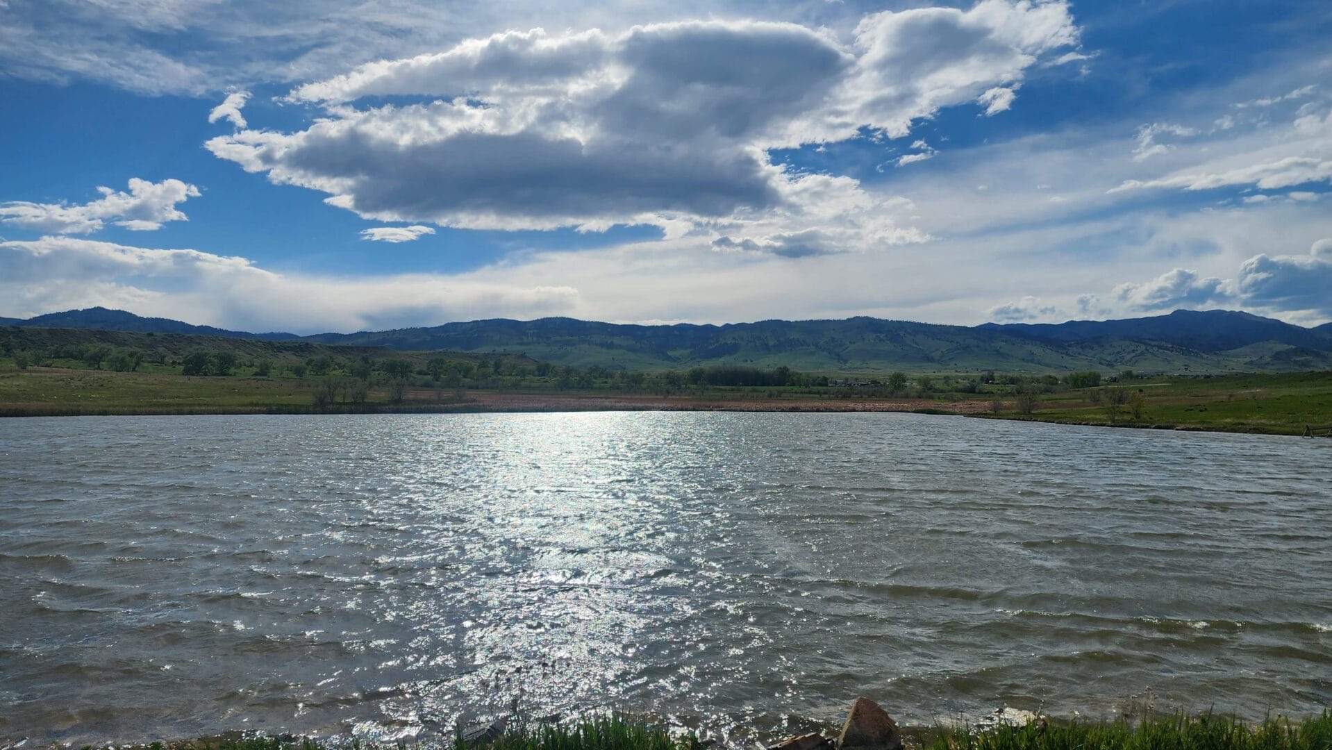 a body of water with hills in the background