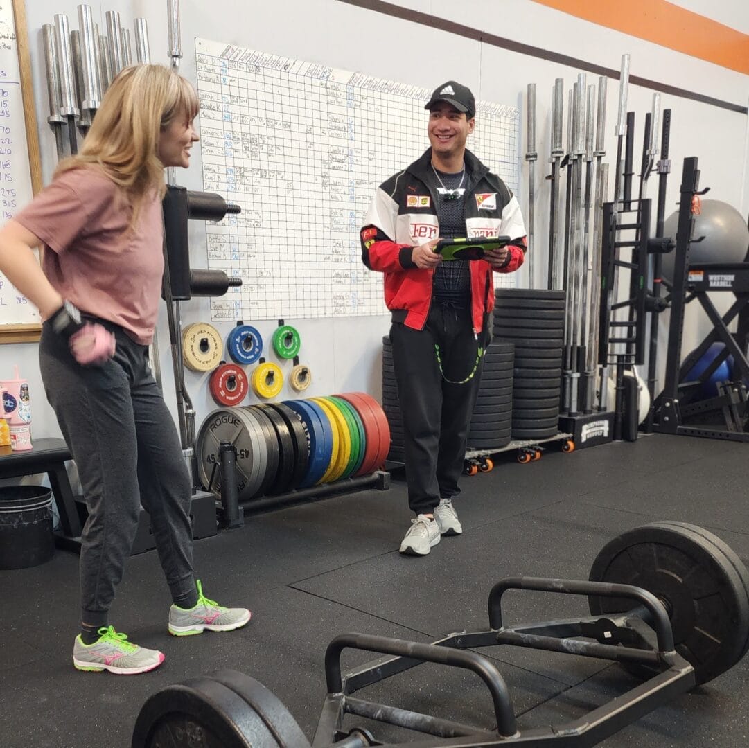 Coach Tristan and Cassie laughing in their personal training session
